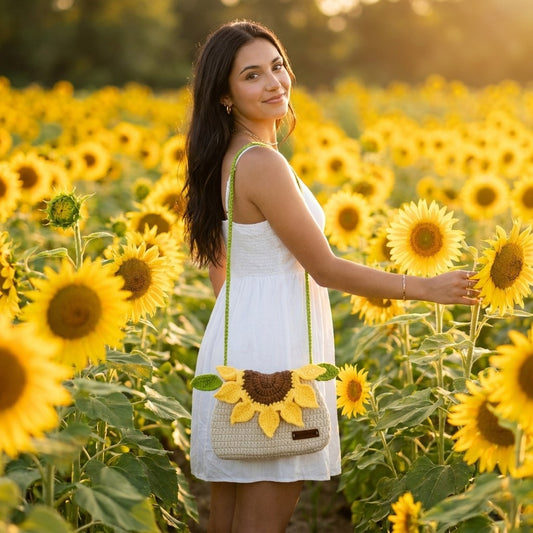 Woman in a white dress holding a sunflower-patterned bag in a sunflower field.