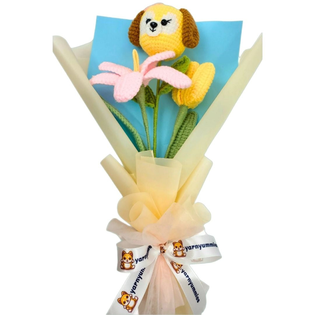 Bouquet of flowers with a small dog-shaped toy attached, wrapped in yellow paper with a white ribbon.