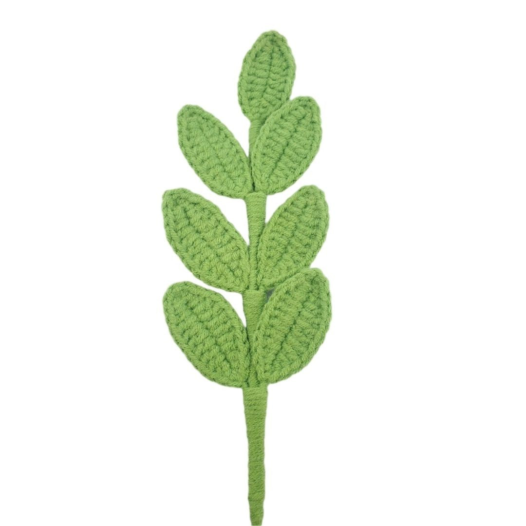 Green crocheted leaf pattern on a white background