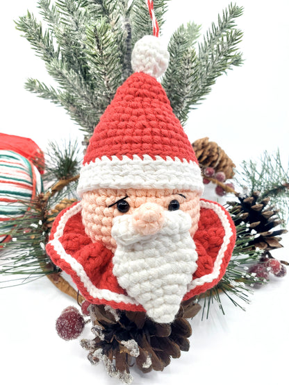 Handmade Santa Claus head ornament with rattle, made of red and white cotton yarn, designed for holiday decoration.