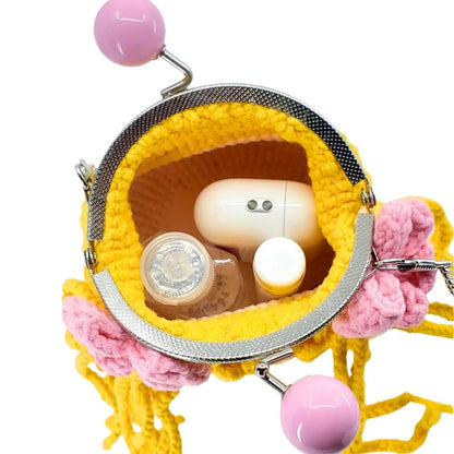 Yellow and pink handbag with a white square object inside on a white background