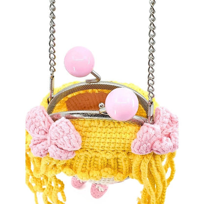 Yellow shoulder bag with pink floral details and a chain strap on a white background