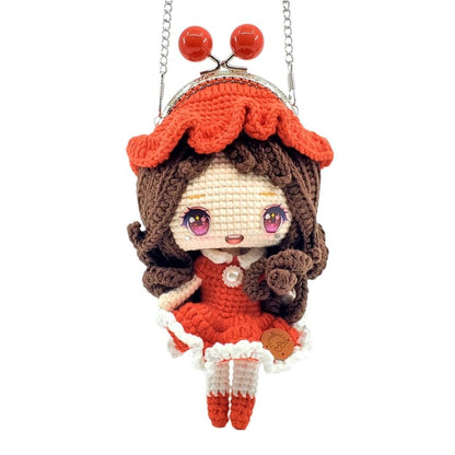 Crocheted doll purse with red dress and red hat on a white background