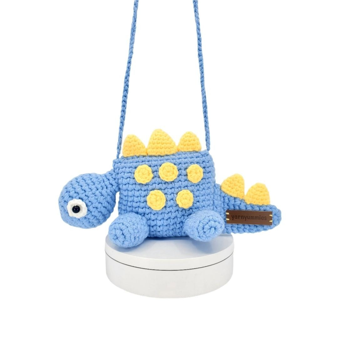 Blue and yellow dinosaur-shaped crossbody bag on a white background