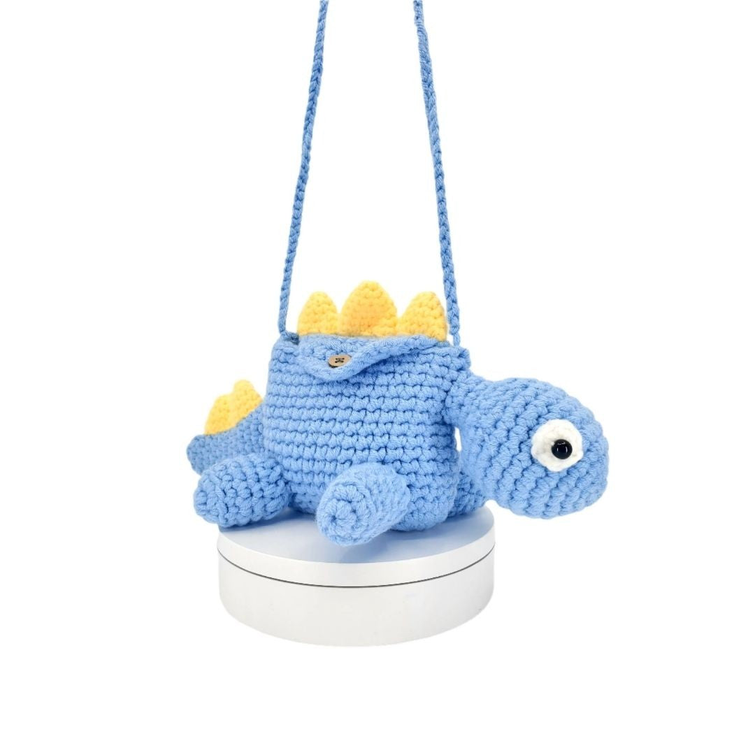 Blue crochet dinosaur bag on a white background