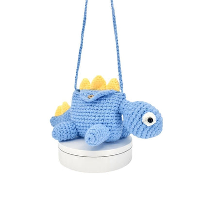 Blue crochet dinosaur bag on a white background