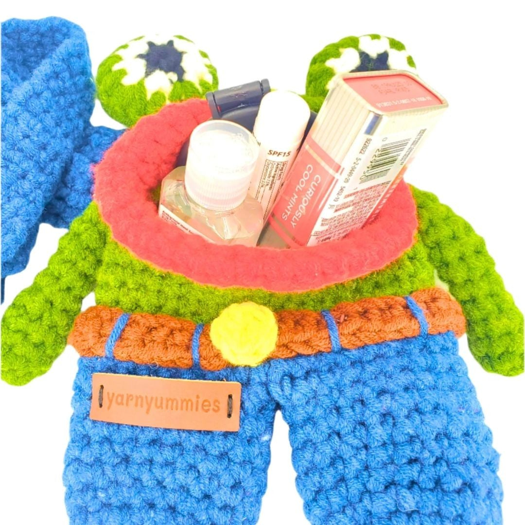 Colorful crocheted frog designed bag with red opening for small items on a white background