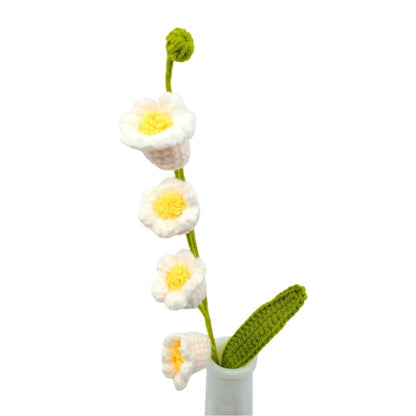 Crocheted May bells flowers in a vase on a white background
