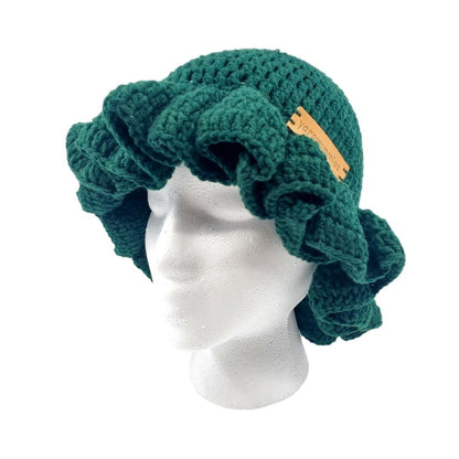Green crocheted ruffled brim bucket hat on a mannequin head with a visible brand logo against a white background