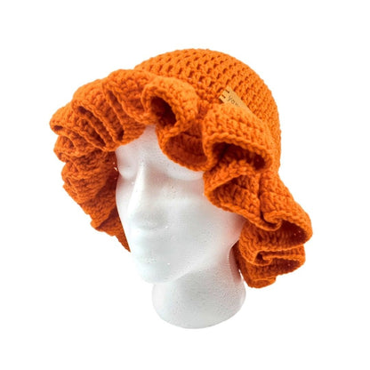 Orange crocheted ruffled brim bucket hat on a mannequin head against a white background