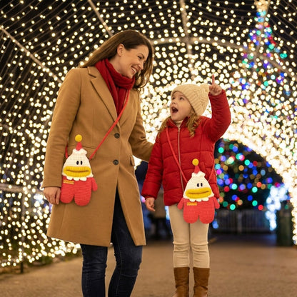 Woman and child walking together with Christmas lights in the background wearing crocheted santa designed  bags