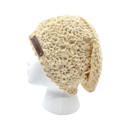 Beige crochet hat on a white mannequin head with a white background