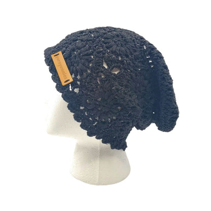 Black knitted hat on a mannequin head with a visible brand tag against a white background