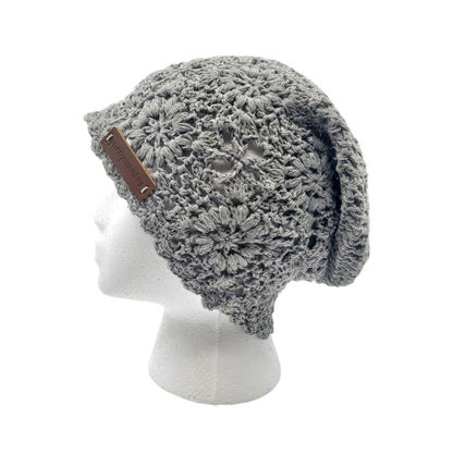 Gray knitted beanie with a brown leather strap on a white mannequin head.