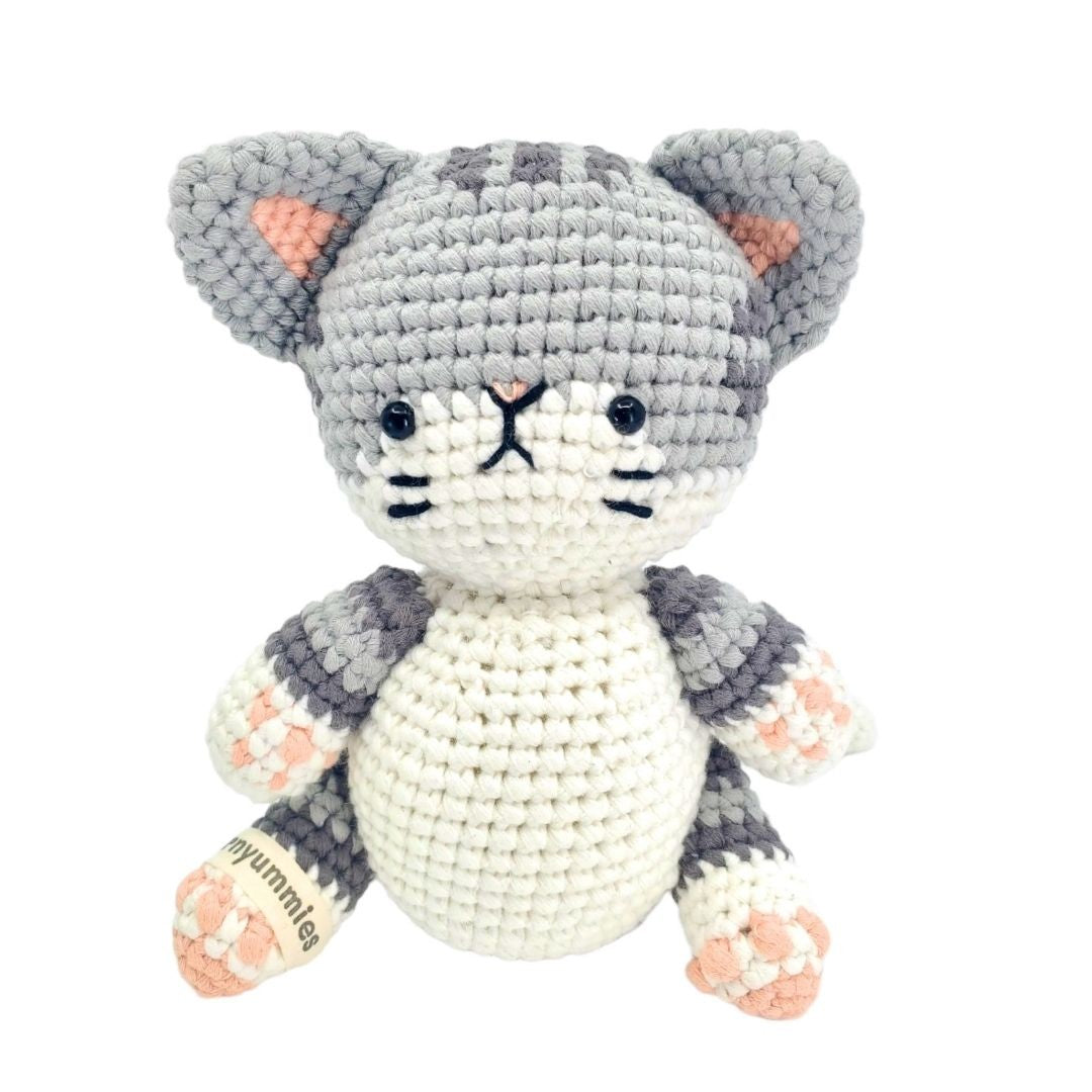 Crocheted cat toy with gray and white pattern on a white background