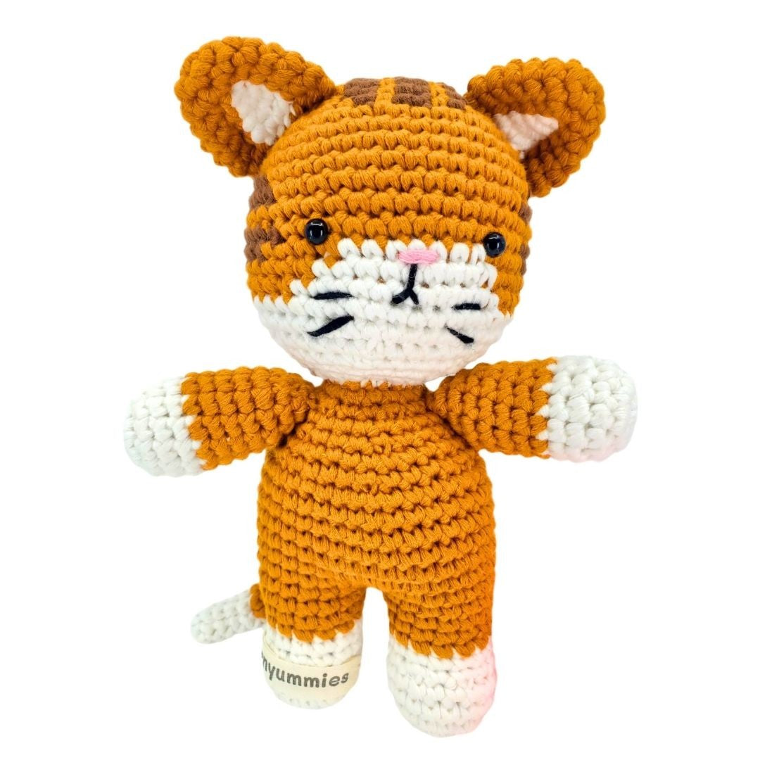 Crocheted toy fox with a white face and orange body on a white background