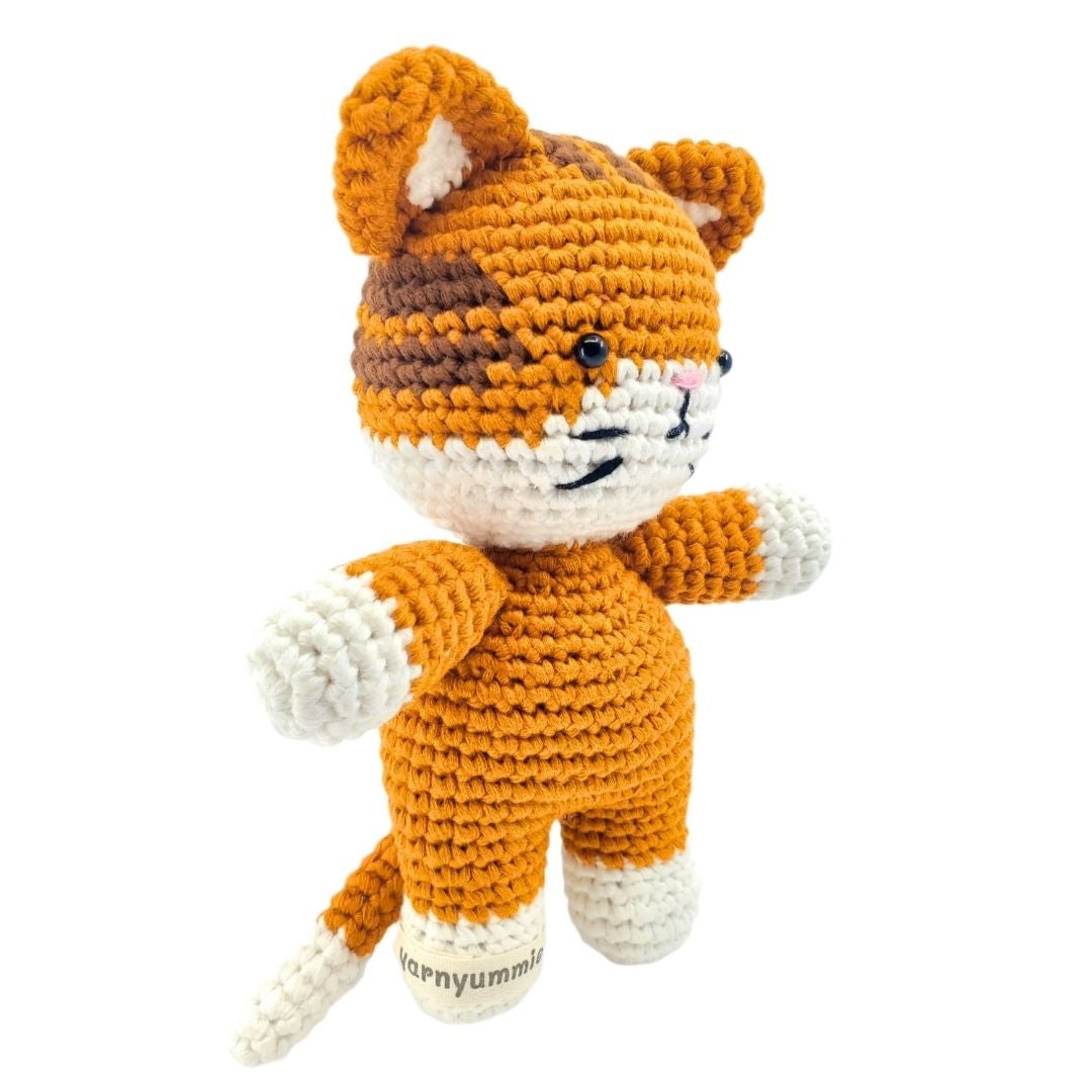 Crocheted tiger plush toy on a white background