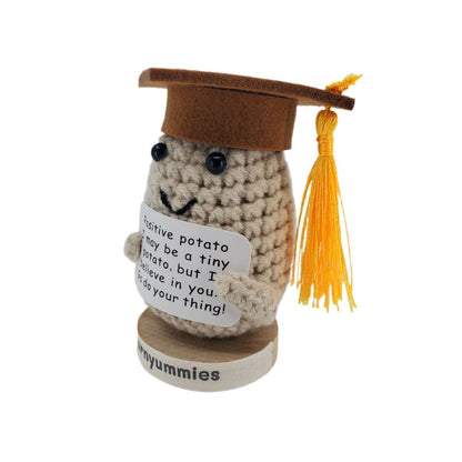 Graduation-themed plush toy with a message tag on a white background