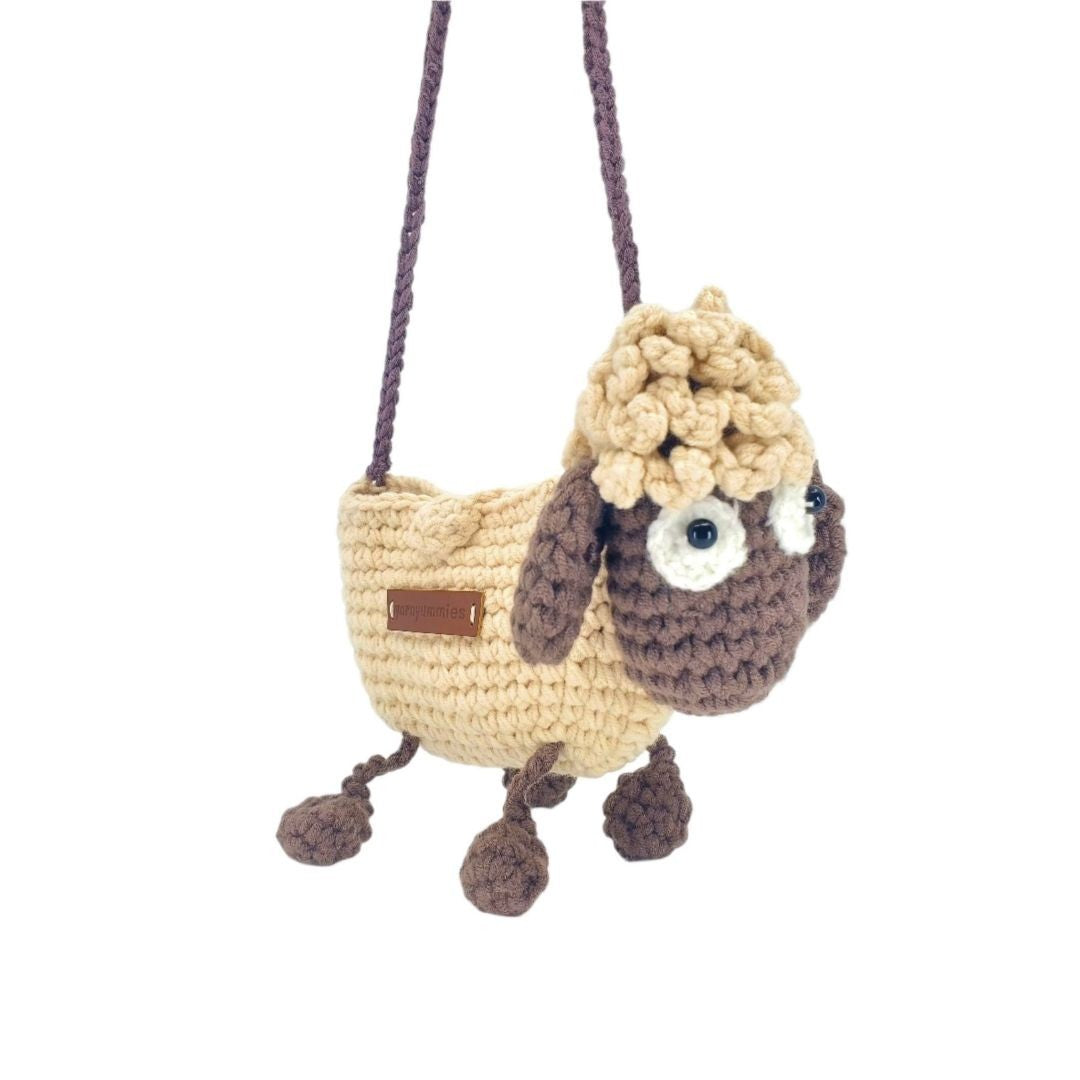 Crocheted lamb-shaped bag with a fluffy head on a white background