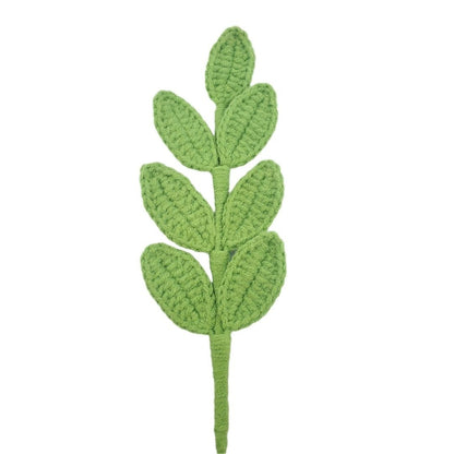 Green crocheted leaf pattern on a white background