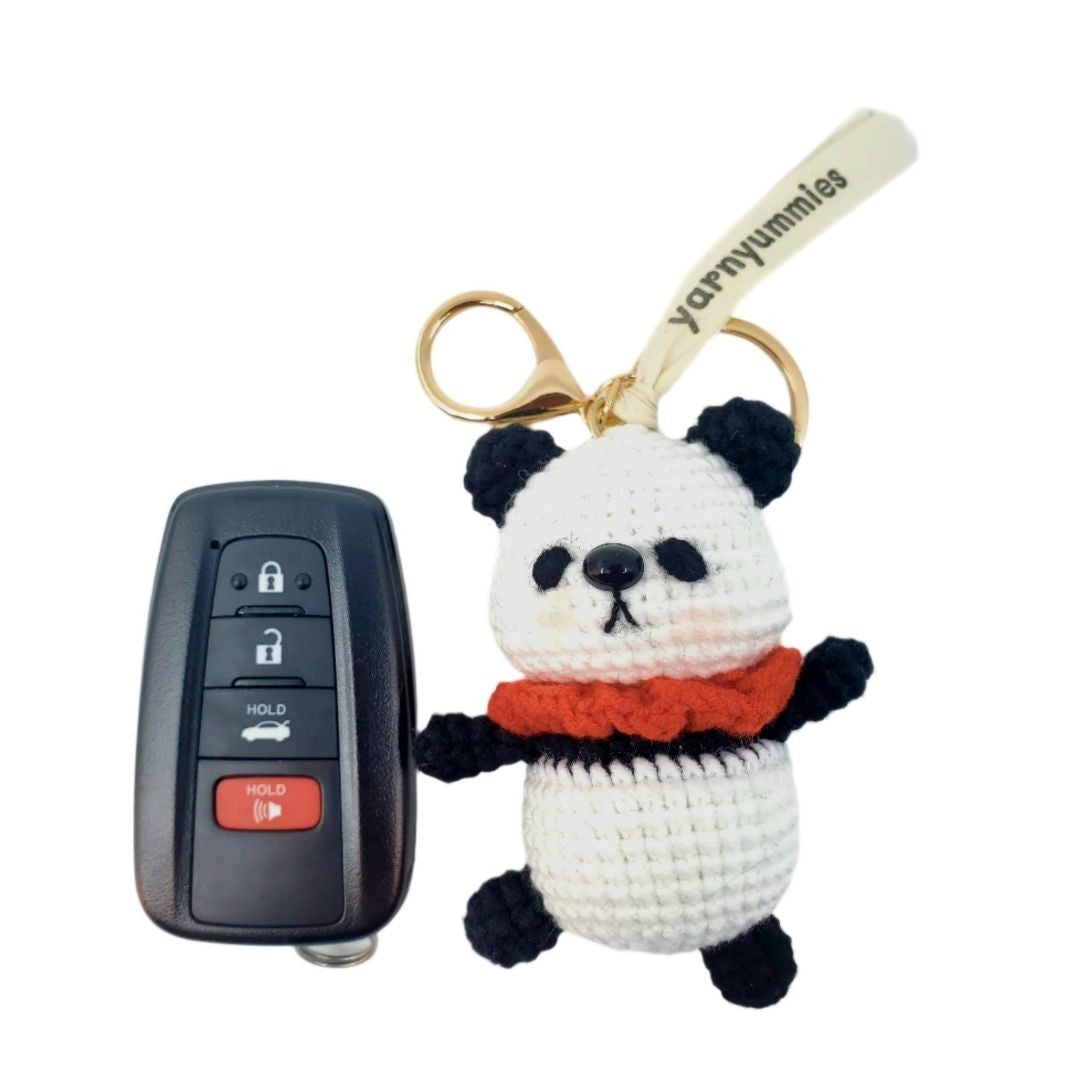 Panda keychain with a car key fob on a white background