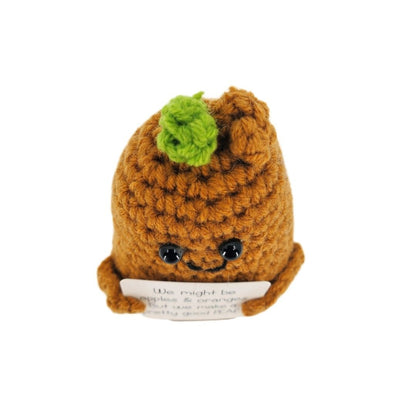 Crocheted pear character with a smiling face on a white background