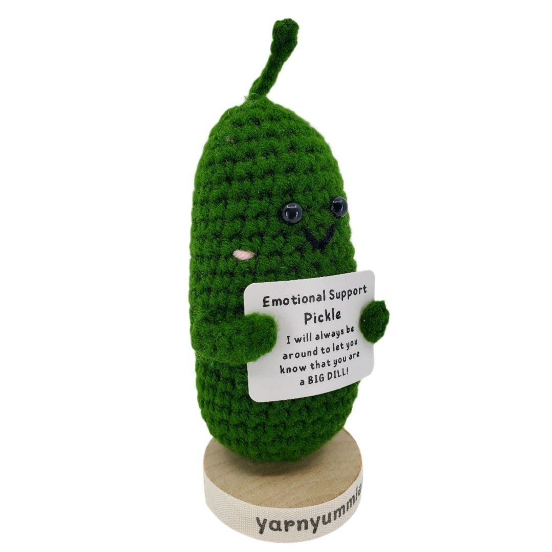 Crocheted pickle plush with a card and 'yarnyummies' branding on a white background