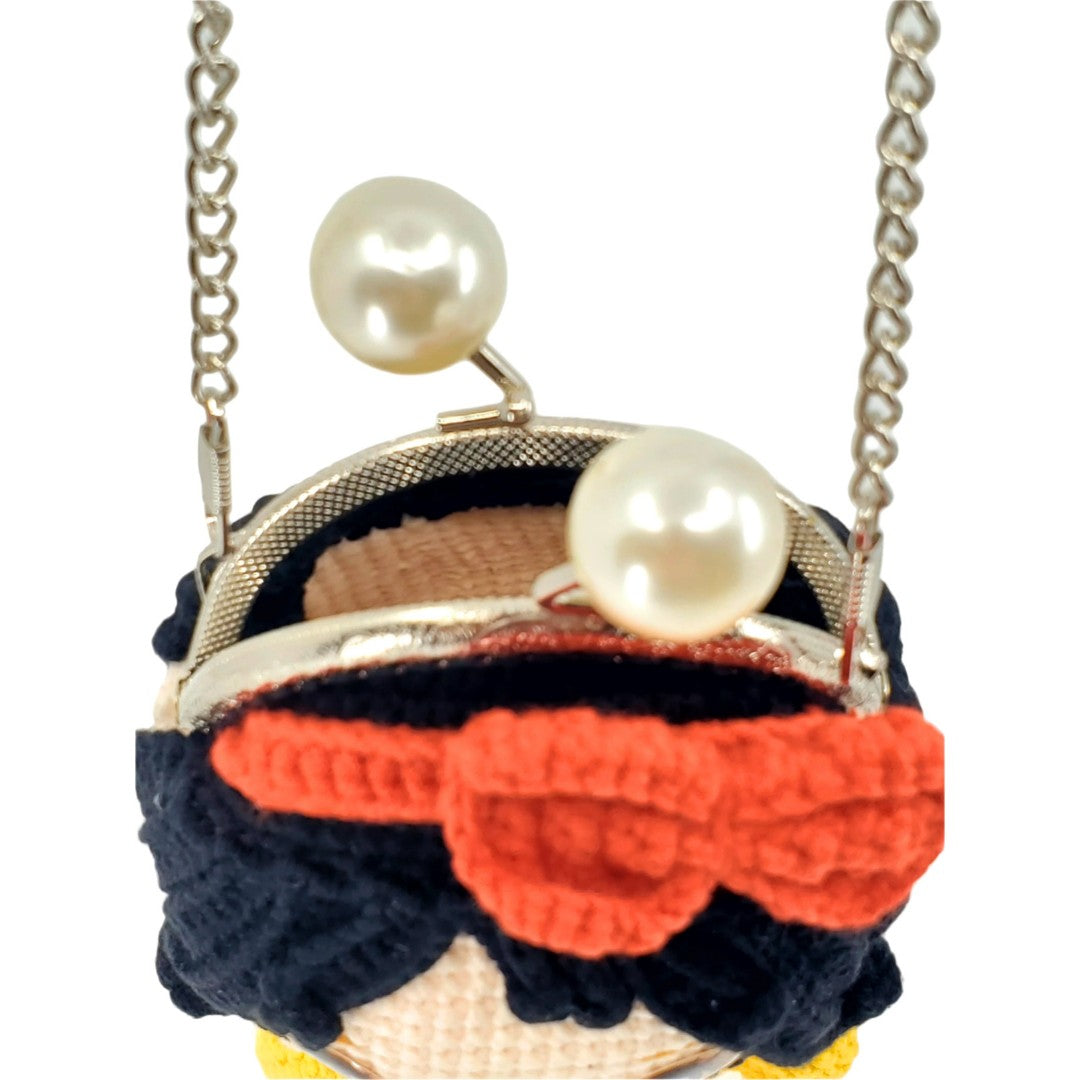 Small handbag with pearls and orange bow on a white background