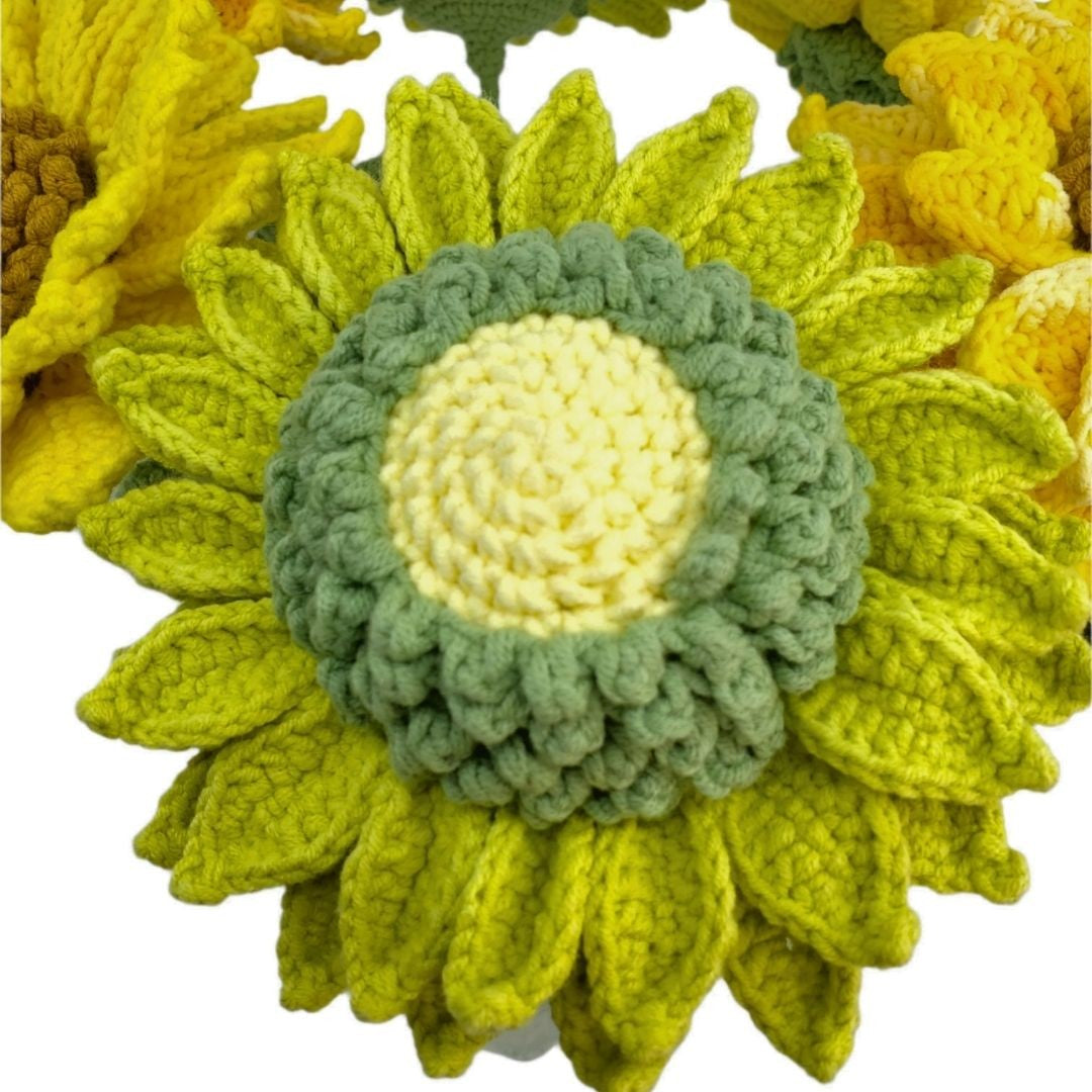 Crocheted sunflower with green center on a white background