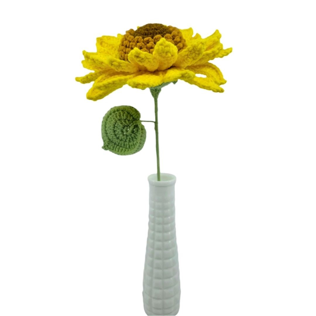 Crocheted sunflower in a white vase on a white background