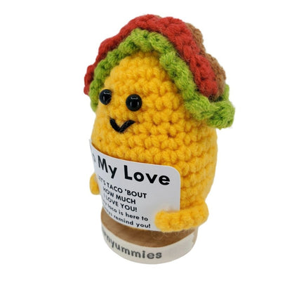 Crocheted taco plush toy with a label on a white background