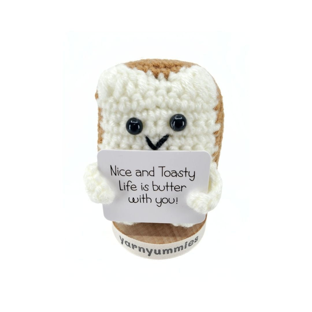 Yarn plush toy resembling a bread toast with a message on a white background