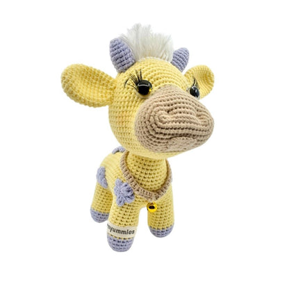 Crocheted yellow cow plushie with a white background